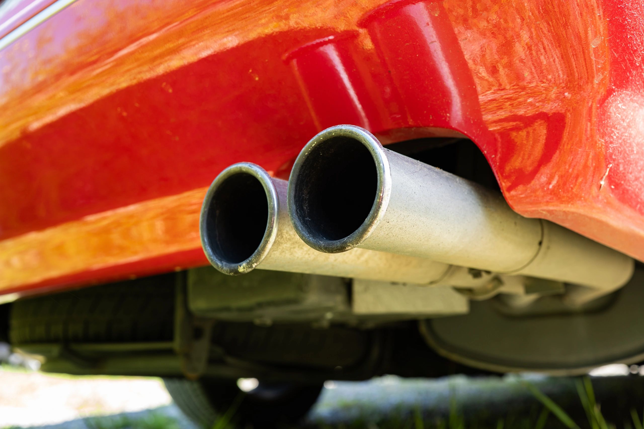 Close-up automotive detail showing polished dual exhaust tips